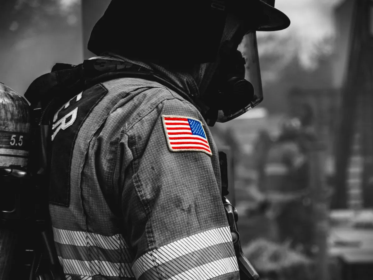 Firefighter wearing breathing apparatus with American flag highlighted